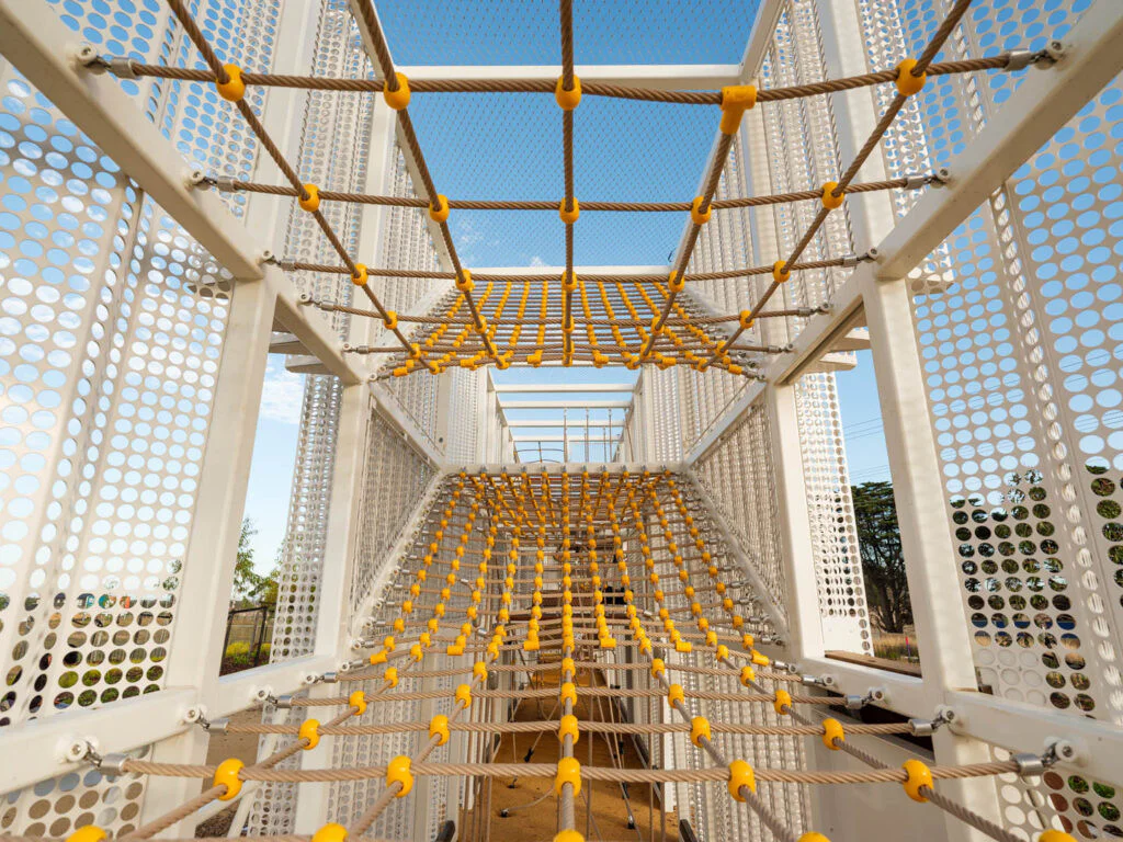 Entry to yellow and white playground equipment